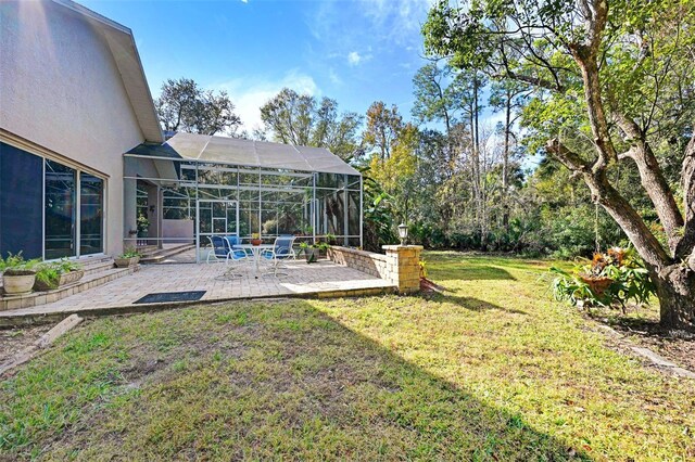 view of yard featuring a lanai and a patio