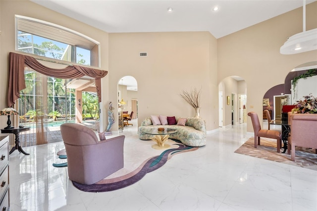 living room with high vaulted ceiling