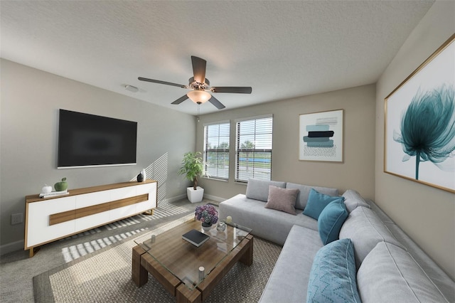 living room featuring a textured ceiling, ceiling fan, and carpet