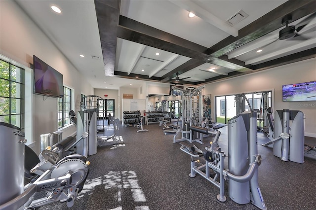 workout area with ceiling fan, a healthy amount of sunlight, and coffered ceiling