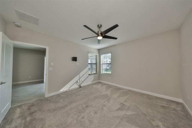 carpeted empty room featuring ceiling fan