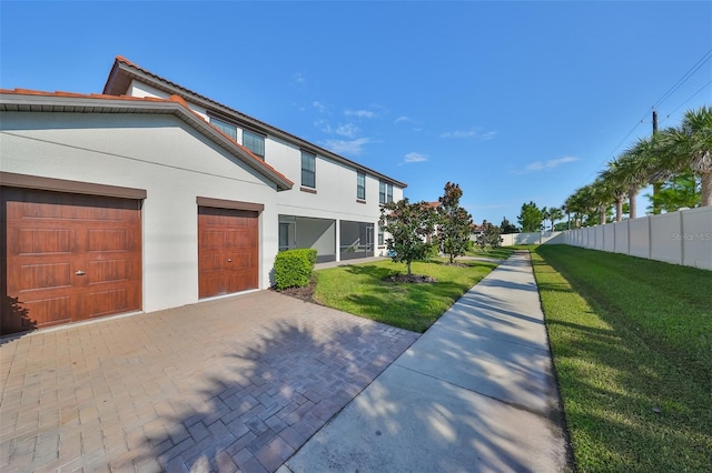 view of side of home featuring a yard and a garage