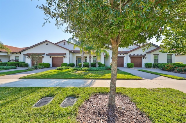 16850 Whisper Elm St, Wimauma, FL 33598 - view of front of house with stucco siding, a front yard, driveway, and a garage