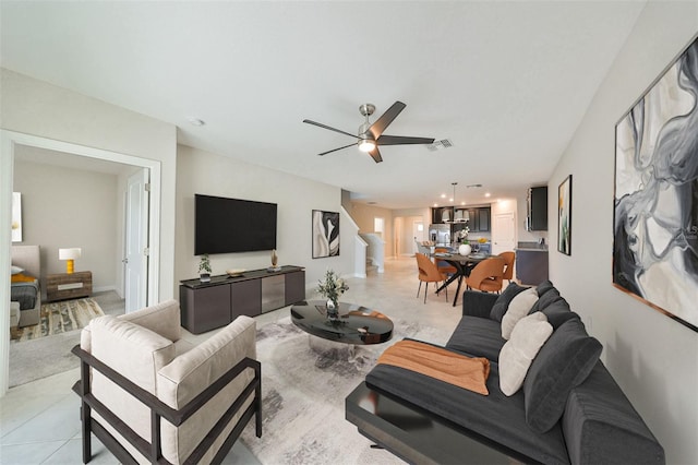 living room with ceiling fan and light tile patterned floors