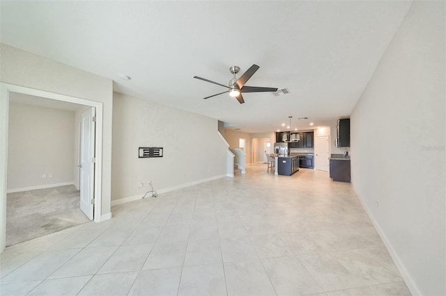 unfurnished living room featuring ceiling fan