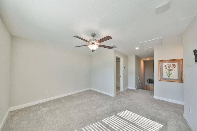 carpeted spare room featuring a textured ceiling and ceiling fan