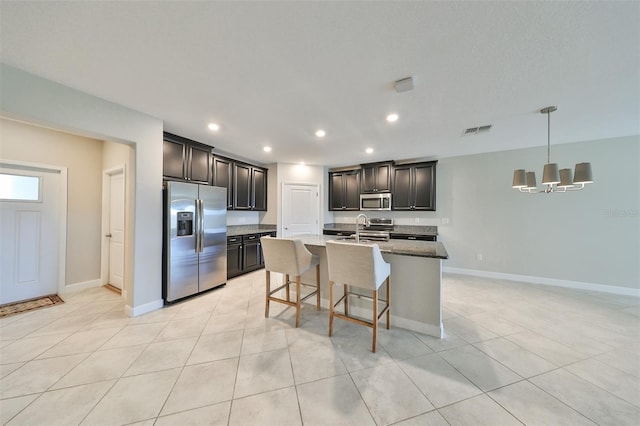 kitchen featuring stainless steel appliances, visible vents, a sink, and light tile patterned flooring