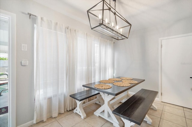 tiled dining area with a chandelier