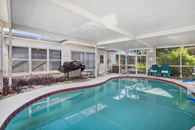 view of pool with glass enclosure