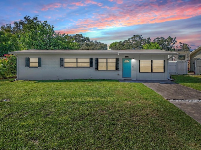 single story home featuring a yard