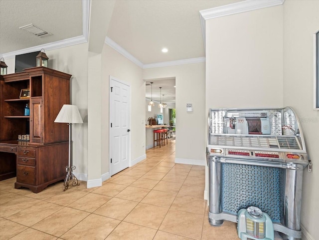 kitchen with light tile patterned floors and ornamental molding