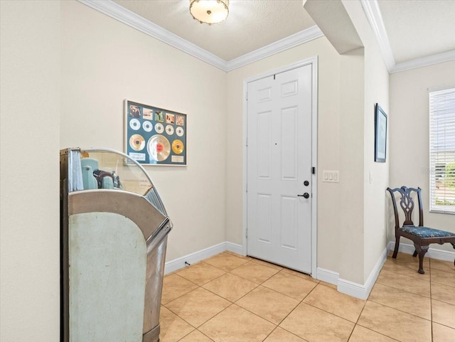 tiled entryway with a textured ceiling and crown molding