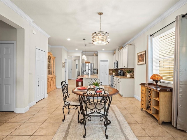 dining space featuring a notable chandelier, crown molding, and light tile patterned floors