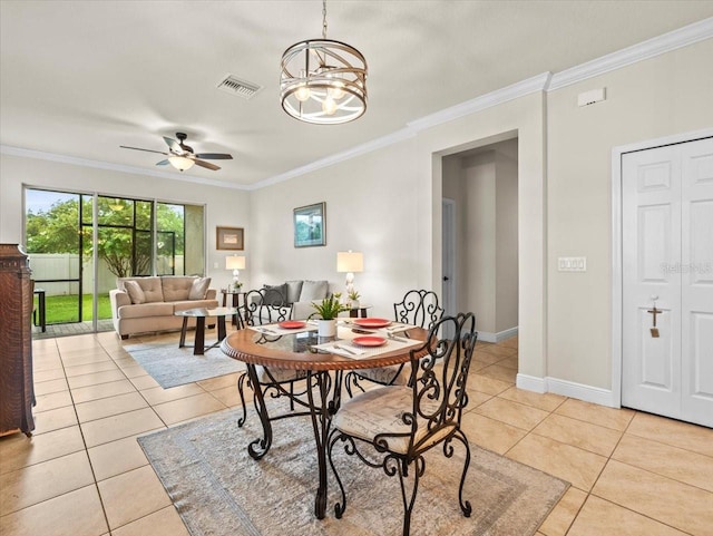 dining area with ceiling fan with notable chandelier, ornamental molding, and light tile patterned floors