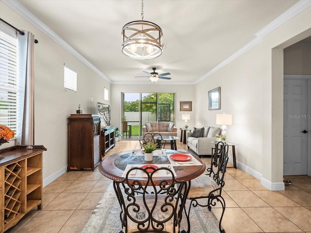 dining area featuring ceiling fan with notable chandelier, light tile patterned flooring, and crown molding