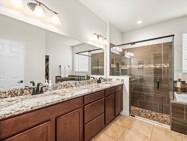 bathroom featuring vanity, an enclosed shower, and tile patterned floors