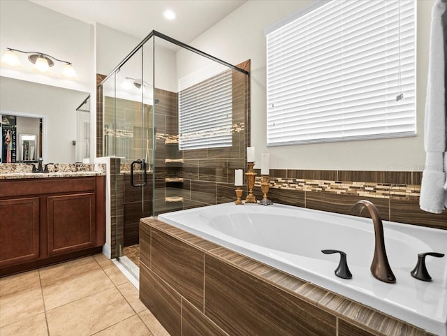 bathroom with tile patterned floors, vanity, and separate shower and tub