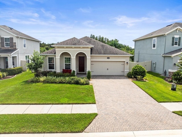 view of front of property with a front lawn and a garage