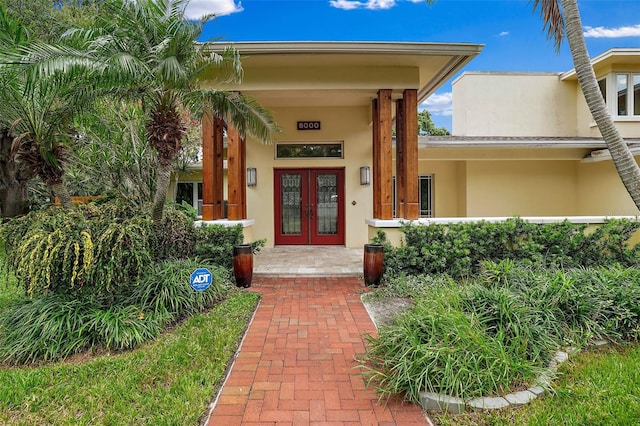 entrance to property featuring french doors and a porch