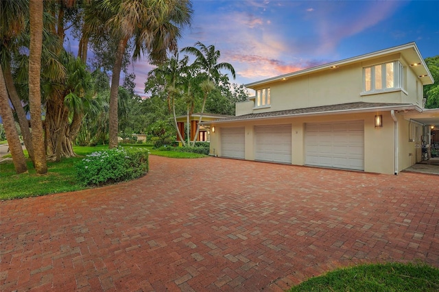 property exterior at dusk with a garage