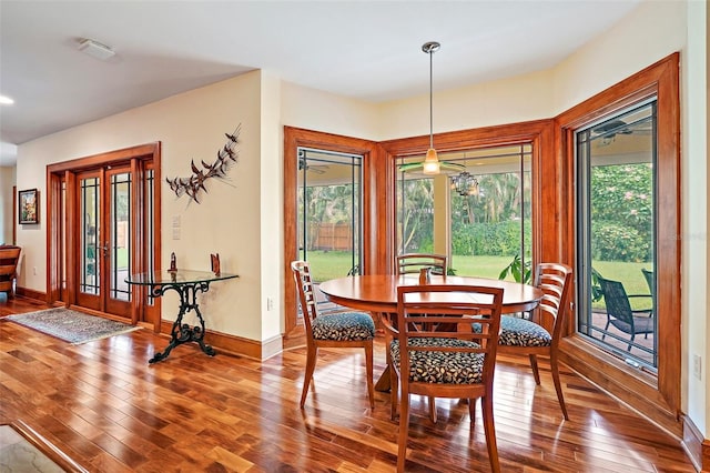 dining area with a wealth of natural light and hardwood / wood-style floors