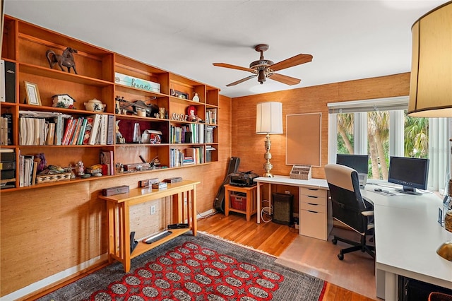 home office featuring light hardwood / wood-style flooring and ceiling fan