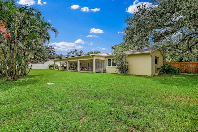 rear view of property with a yard