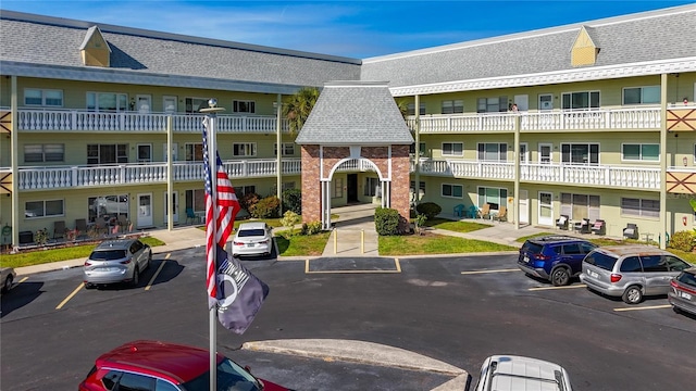 view of building exterior with uncovered parking