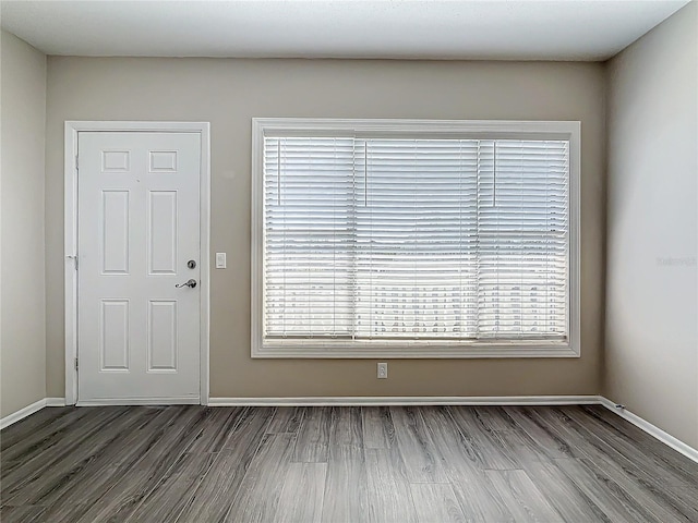 foyer entrance featuring wood finished floors and baseboards