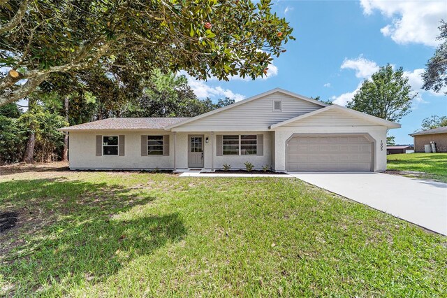 single story home featuring a garage and a front yard