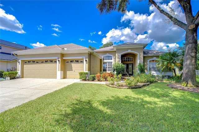 mediterranean / spanish-style home featuring a front lawn and a garage