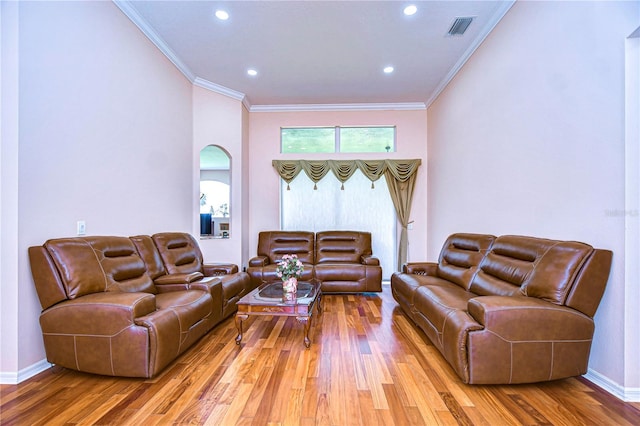 living room with wood-type flooring and ornamental molding