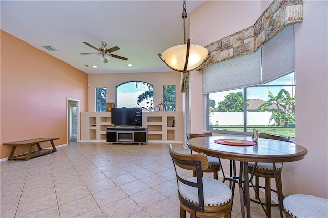 tiled dining area featuring ceiling fan