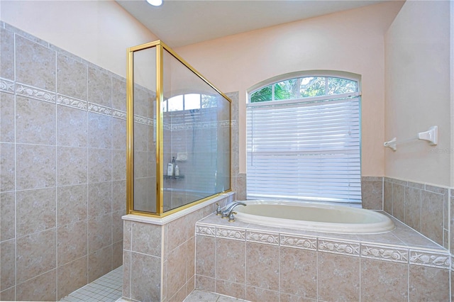 bathroom with separate shower and tub