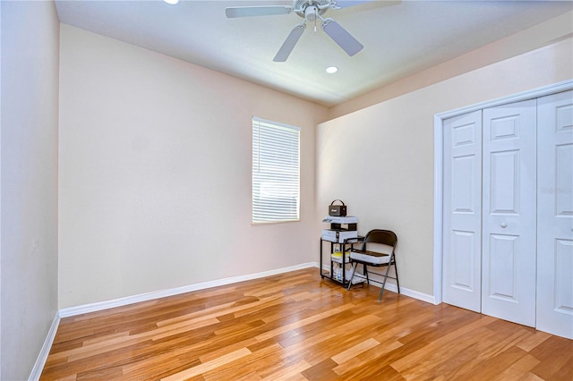 bedroom featuring ceiling fan, light wood-type flooring, and a closet