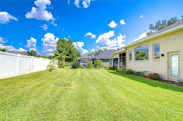 view of yard with a lanai