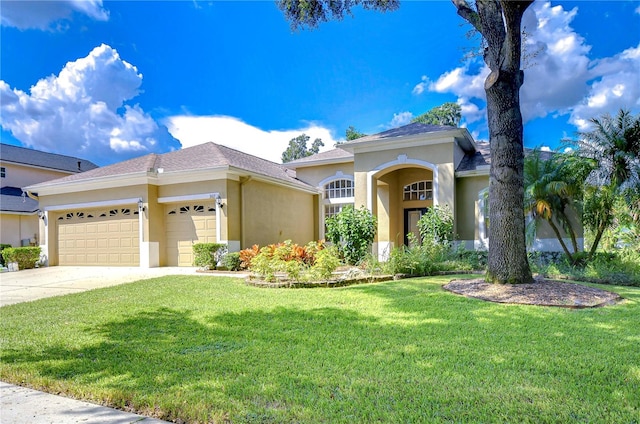 view of front of house with a front yard and a garage