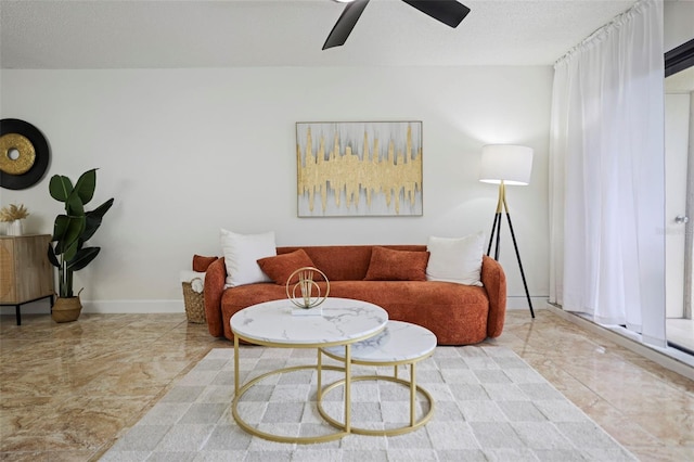 living room featuring a textured ceiling and ceiling fan