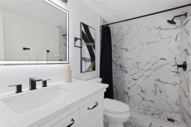 bathroom with vanity, curtained shower, and toilet