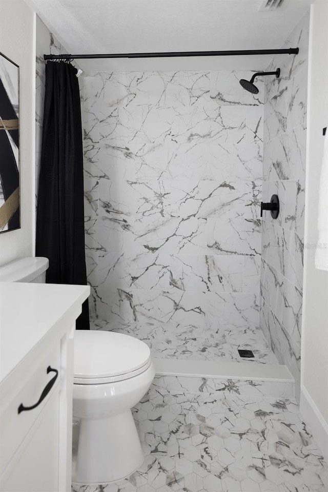 bathroom featuring vanity, toilet, and a shower with shower curtain