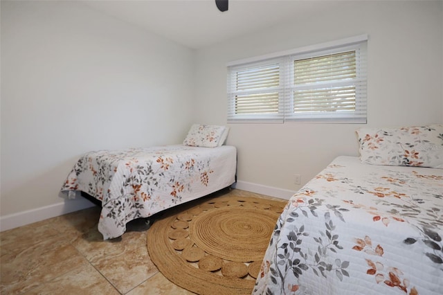 bedroom featuring tile patterned floors and ceiling fan