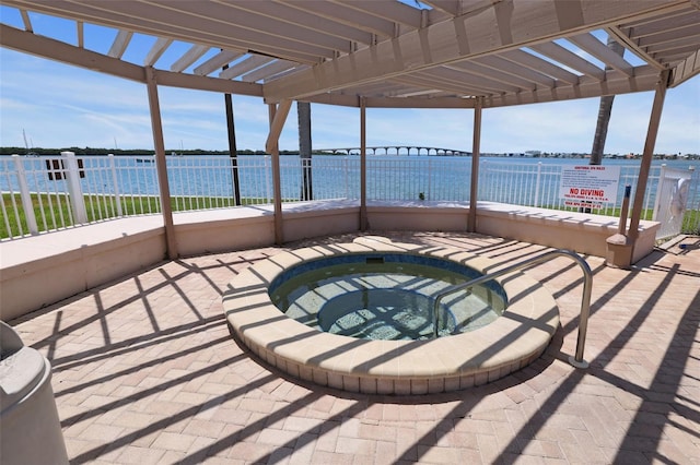 view of patio / terrace featuring a community hot tub, a water view, and a pergola