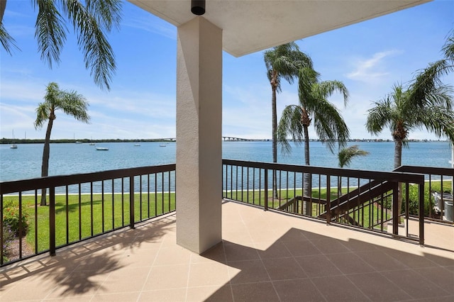 view of patio / terrace featuring a water view and a balcony