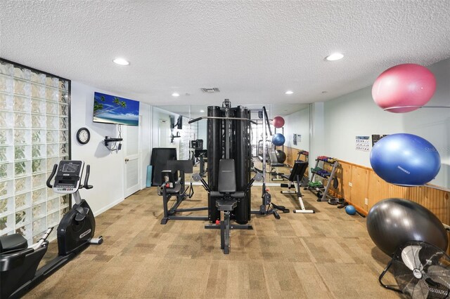 6291 Bahia Del Mar Cir Unit 103, Saint Petersburg, FL 33715 - exercise room featuring recessed lighting, a textured ceiling, visible vents, and carpet flooring