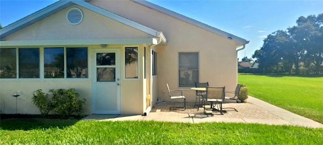 back of house featuring a yard and a patio area