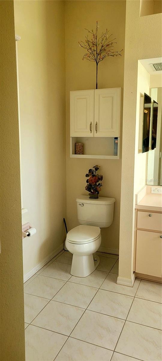 bathroom featuring vanity, toilet, and tile patterned floors