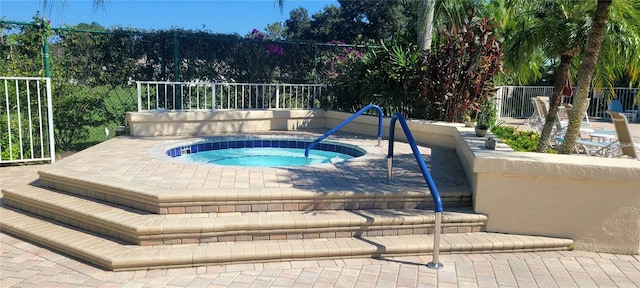 view of pool with an in ground hot tub