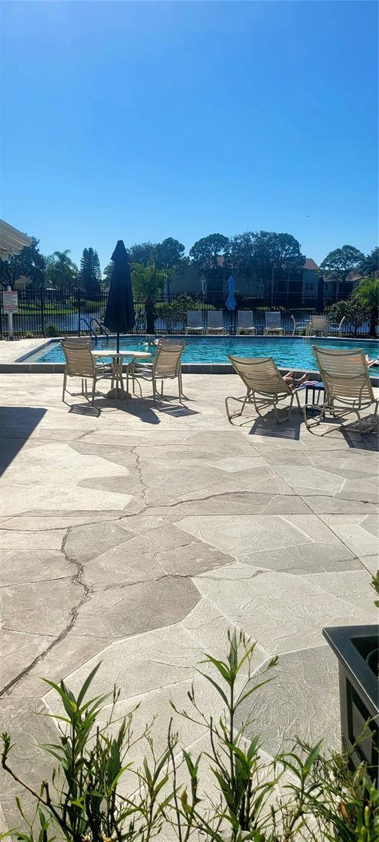 4432 Whitton Way, New Port Richey, FL 34653 - community pool featuring a patio