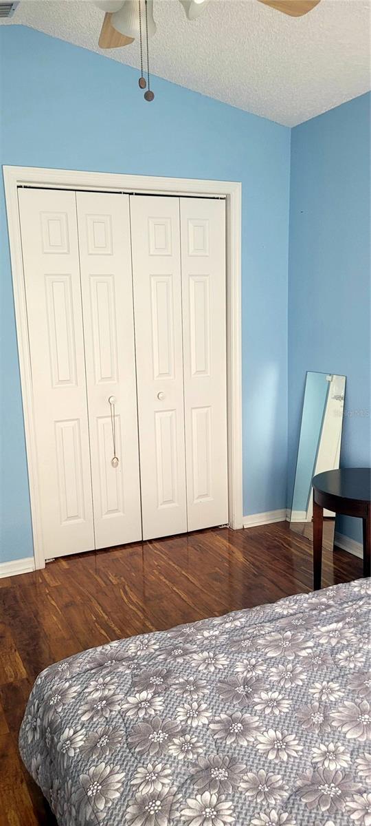 4432 Whitton Way, New Port Richey, FL 34653 - bedroom with wood finished floors, a closet, a textured ceiling, and ceiling fan
