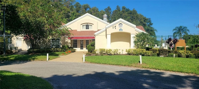 4432 Whitton Way, New Port Richey, FL 34653 - mediterranean / spanish home featuring stucco siding, a front yard, and french doors